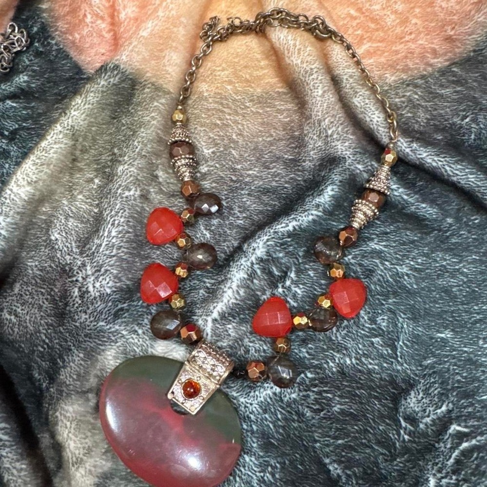 'Red and brown beaded necklace with heart-shaped pendant'